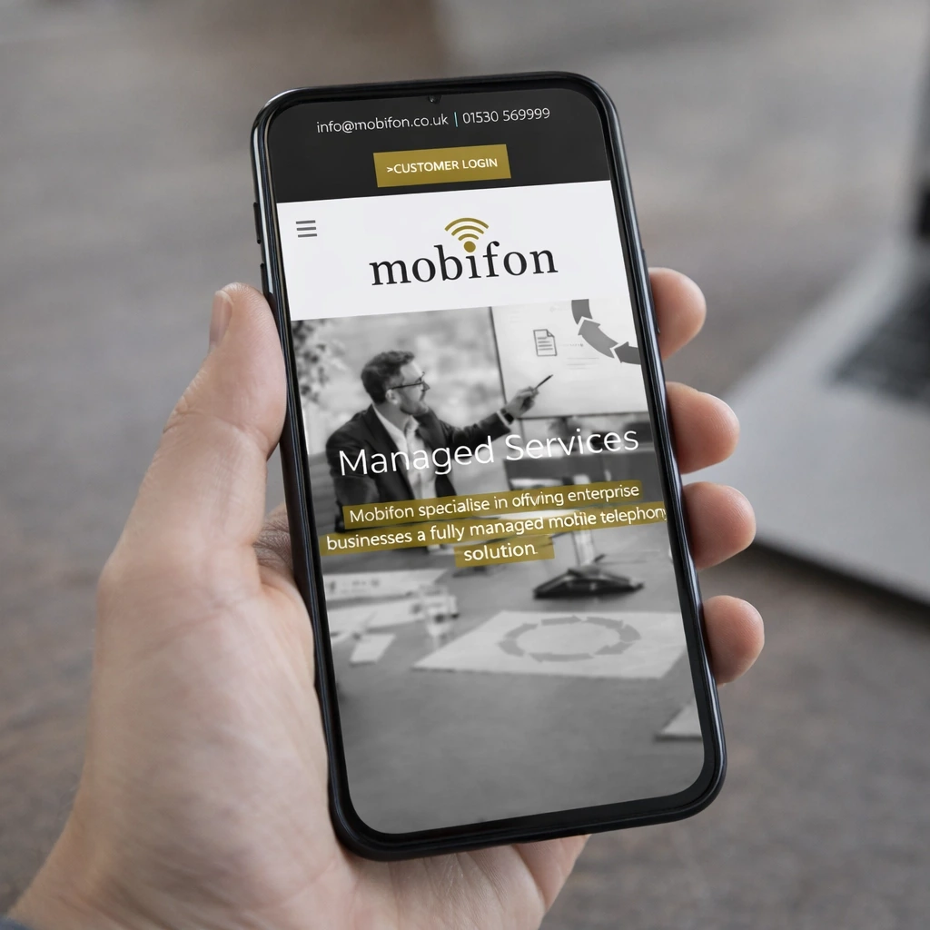 Person holding a smartphone displaying the Mobifon Managed Services webpage.